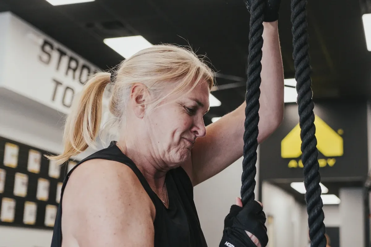 A member works through a heavy rope exercise near the end of a session at an Alloy Personal Training studio